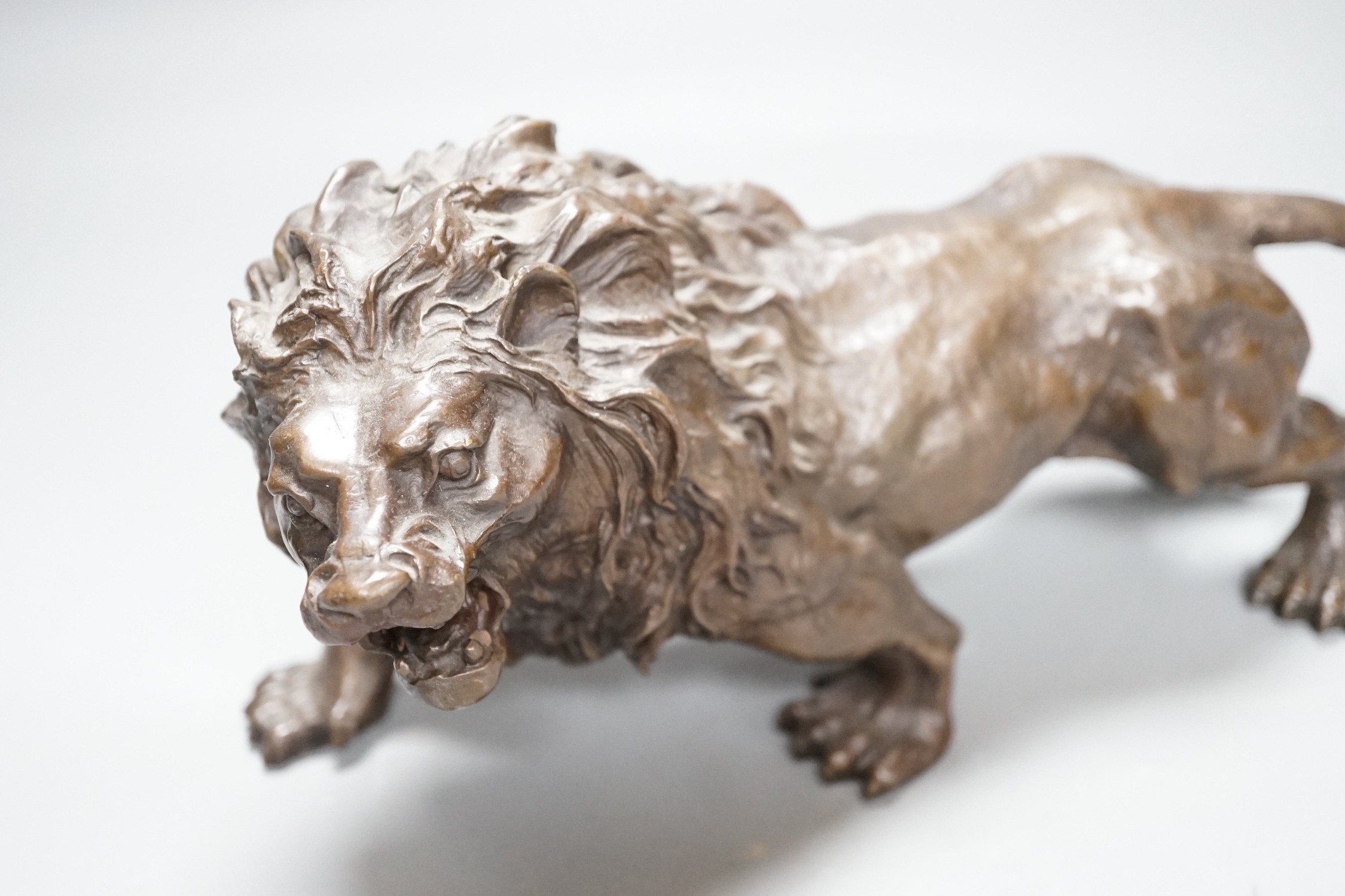 A 20th century bronze figure of a lion, 30cm long